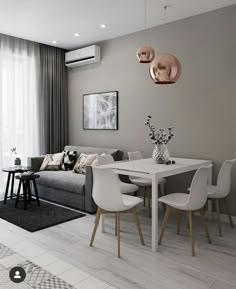 a living room with a couch, table and chairs next to a wall mounted air conditioner