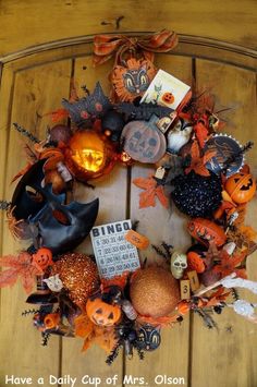 a halloween wreath with pumpkins and other decorations