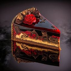 a piece of cake with red and gold decorations on it's side is reflected in the water