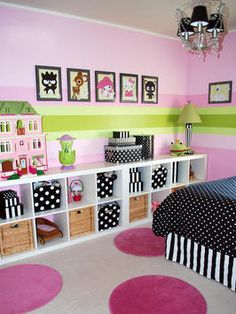 a child's bedroom decorated in pink, green and white with polka dot rugs