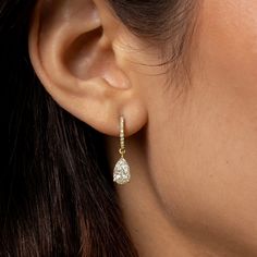 Simply elegant, and absolutely gorgeous. Welcome these timeless diamond dangle earrings into your life! We make our pear cut diamond drop, diamond huggie hoop earrings in your choice of 18k gold (rose, yellow, or black, or white). Here, in 18k yellow gold. 18k yellow gold pear cut diamond drop earring on diamond-faced hinged huggie hoops. 2.12cts (pair) of white diamonds. F color, VS1 clarity 18k yellow gold hardware. Diamond-faced hinged huggie hoop earwires with hidden closure. Lovingly, skill Luxury Yellow Gold Huggie Earrings For Wedding, Luxury Classic Huggie Earrings For Wedding, Timeless Luxury Huggie Diamond Earrings, Luxury Halo Huggie Earrings For Wedding, Luxury Huggie Dangle Earrings, Luxury Dangle Huggie Earrings, Diamond Dangling Earrings, Luxury Pear-shaped Hoop Earrings For Formal Occasions, Dangling Diamond Earrings