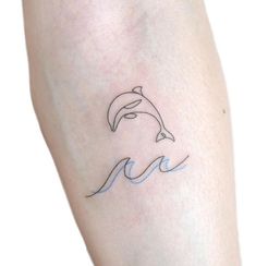 a small dolphin tattoo on the leg