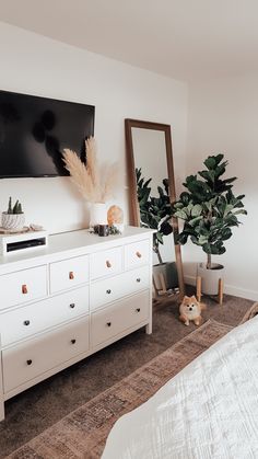 a bedroom with white furniture and plants in the corner, text overlay reads cover your electronics box with this stylish day