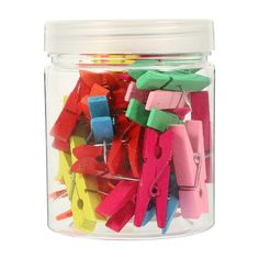 a jar filled with assorted colored clothes pins