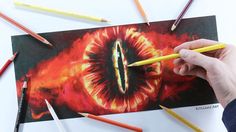 a person is drawing an eye with colored pencils