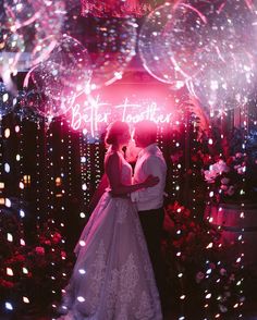 a bride and groom kissing in front of fireworks at their wedding reception with the words better together written on it