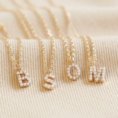 This gorgeous little necklace is the perfect jewellery piece for wearing alone, layering up or giving as a gift! The necklace features a small initial covered in tiny imitation pearls, suspended from a delicate trace chain that fastens via lobster clasp. A must-have for lovers of gold jewellery, this necklace is plated in polished 14ct gold. Pearl Letter Necklace, Pearl Initial Necklace, Fantasy Earrings, Small Letter, Preppy Jewelry, Sweet Necklace, Jewelry Accessories Ideas, Letter Charm, Jewelry Lookbook