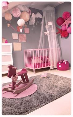 a baby's room decorated in pink and gray