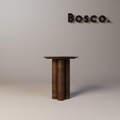 the table is made out of wood and has an inscription above it that reads bosco