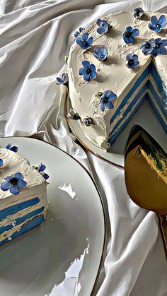 two pieces of cake sitting on plates next to each other with blue flowers painted on them