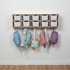 a wall mounted shelf filled with lots of baby items next to baskets and umbrellas