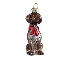 a glass ornament shaped like a dog with a red bow on its collar