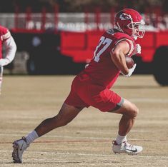 a football player is running with the ball