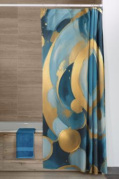 a blue and gold shower curtain in a bathroom with wood flooring next to a bathtub