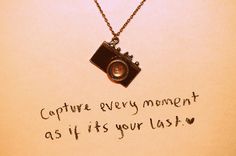 a necklace with a camera on it that says capture every moment as if your last