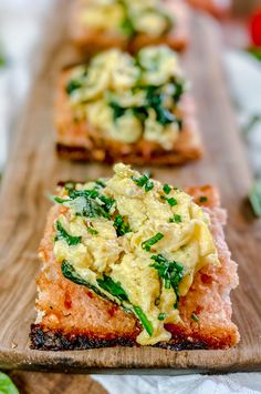 three slices of bread topped with cheese and spinach