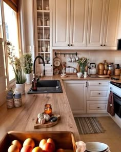 a kitchen filled with lots of white cabinets and counter top space next to a sink