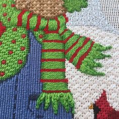 a close up of a knitted christmas sweater with an elf's hat and mittens