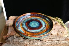 a bowl sitting on top of a piece of wood