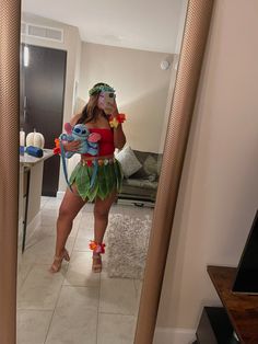 a woman is taking a selfie in the mirror with her stuffed animal and costume