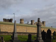 an old cemetery in front of a castle