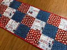 a red, white and blue table runner on a wooden floor