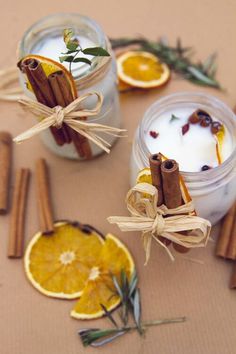 homemade diy christmas candles with cinnamon sticks and orange slices