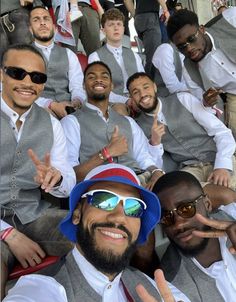 a group of men wearing sunglasses and vests