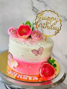 a birthday cake decorated with flowers and butterflies