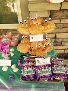 a table topped with lots of food covered in googly eyes and candies on top of it