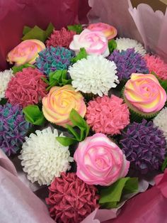 a bouquet of flowers is wrapped in pink and white paper