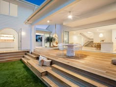 an outdoor living area with wooden steps and grass