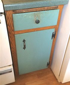 an old fashioned blue cabinet in a kitchen