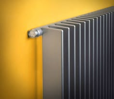 the radiator is mounted on the yellow wall