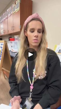 a woman sitting in a chair wearing a headband