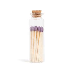 matchsticks in a glass jar on a white background