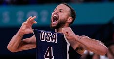 a man holding a basketball in his right hand and making a face with his left hand