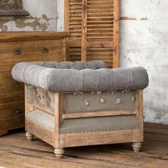 an old wooden bench sitting on top of a hard wood floor next to a dresser