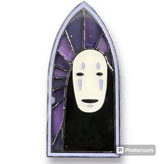 a white mask with purple and black stained glass in the shape of a church window