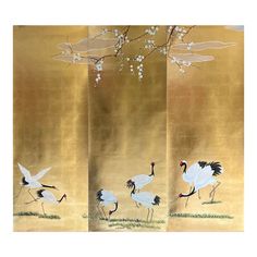 three panels with birds and flowers painted on gold foiled paper, each panel has an image of two cranes in flight