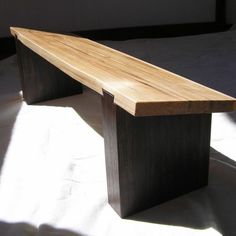 a wooden bench sitting on top of a bed