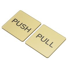 two yellow push buttons with the word pull written on one side and the word push printed on the other