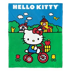 a hello kitty towel with an image of a cat on a bike in the background