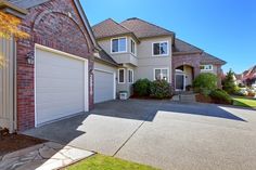 a large house with two garages in front of it