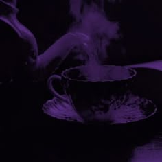 a steaming cup and saucer on a table