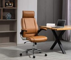 a brown office chair sitting in front of a laptop computer on top of a wooden desk