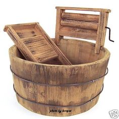 an old wooden bucket with some sort of seat in it's bottom section and the lid open