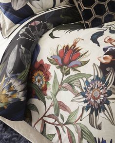 an image of a bed with floral designs on the comforter and pillowcases