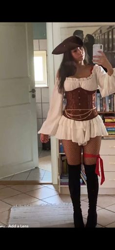 a woman in a pirate costume taking a selfie