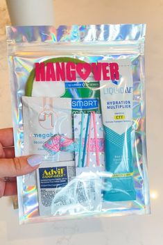 a person holding up a clear bag with toothbrushes and lotion